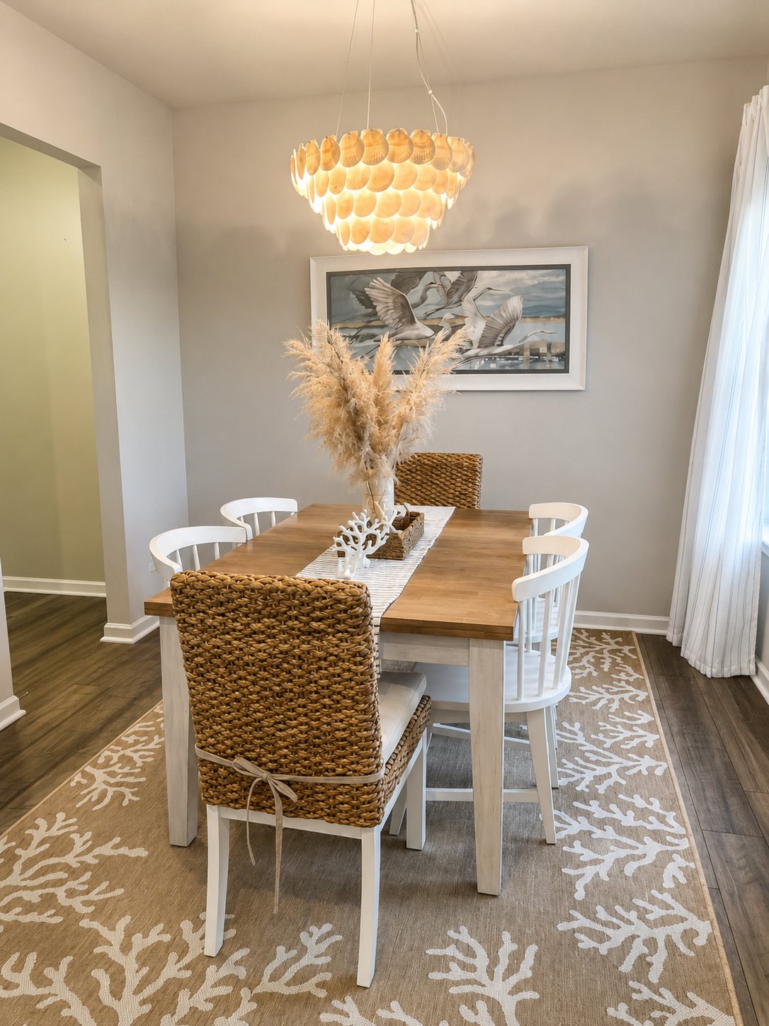 Coastal dining room with a shell chandelier